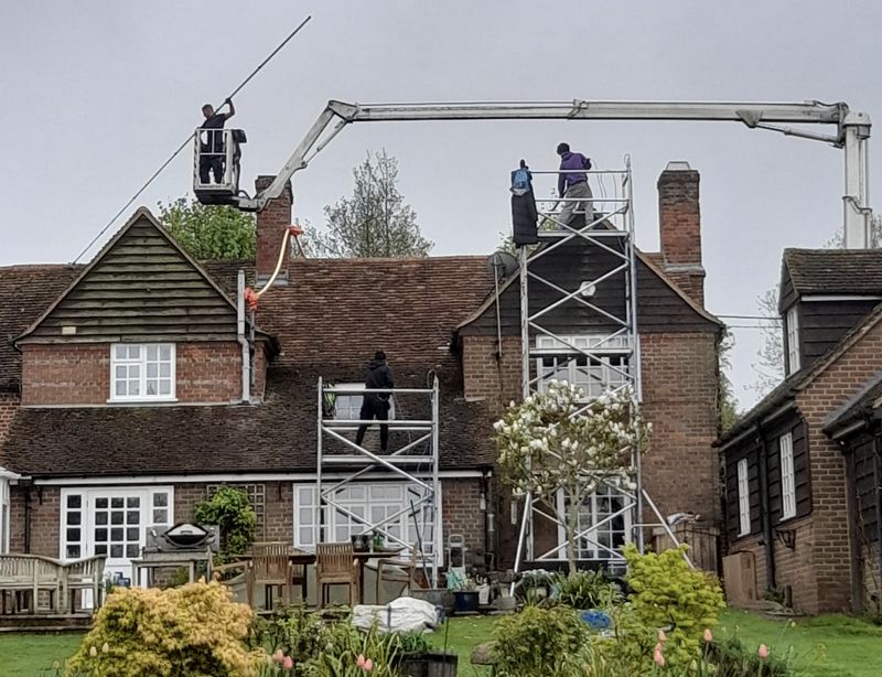 The Moss Cleaners using cherry picker and scaffolding to clean roof safely and professionally in Bedworth, Warwickshire